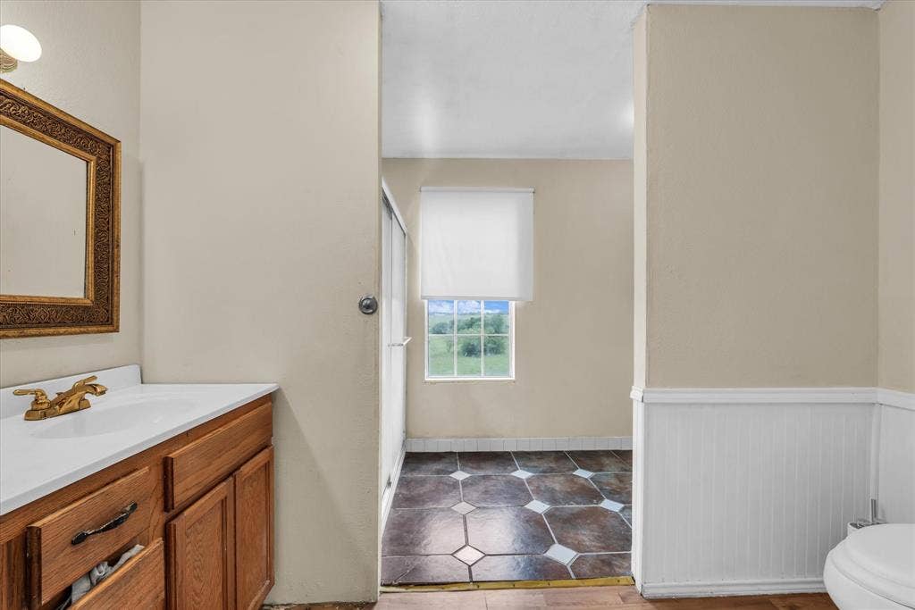 12912 Spring Valley Road, Moody, TX 76557 Bathroom vanity with a white countertop and gold-toned faucet