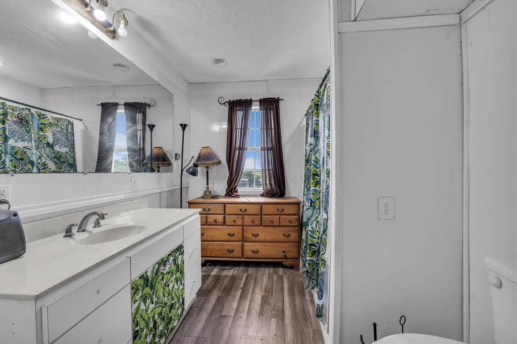 12912 Spring Valley Road, Moody, TX 76557 Bathroom featuring a white vanity with an integrated sink, brushed nickel faucet, and a large mirror