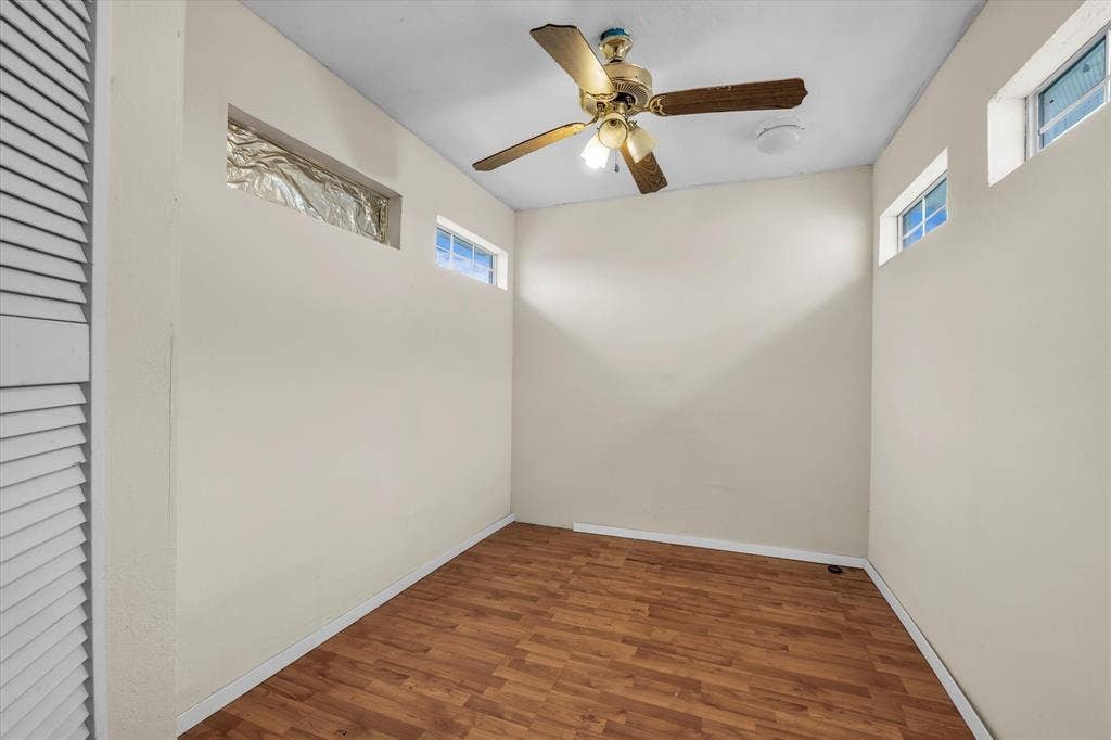 12912 Spring Valley Road, Moody, TX 76557 Room featuring wood-finish flooring, a ceiling fan with integrated lighting, and multiple transom windows
