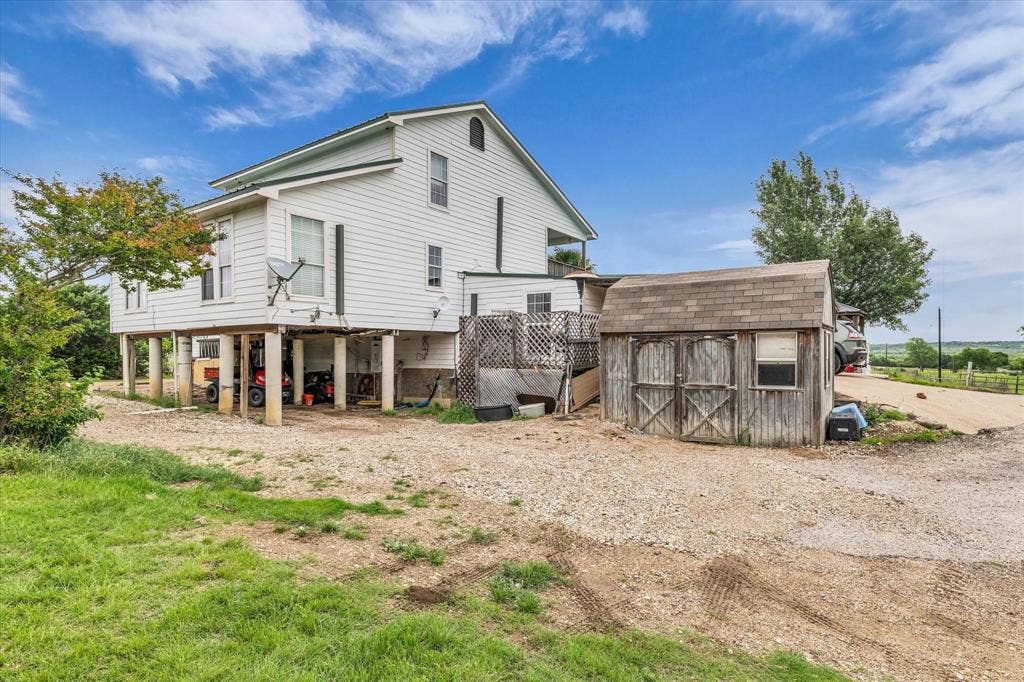 12912 Spring Valley Road, Moody, TX 76557 Elevated white-sided residence with multiple windows and a metal roof