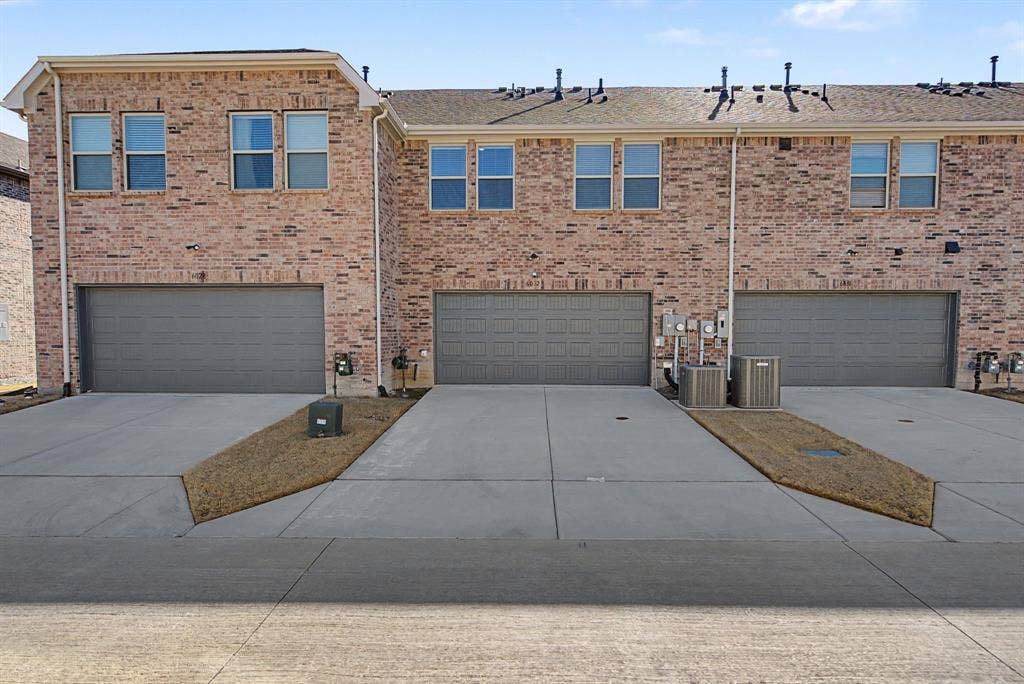 6032 Silverado Trail, McKinney, TX 75070 Brick facade townhome with individual garage and dedicated driveway