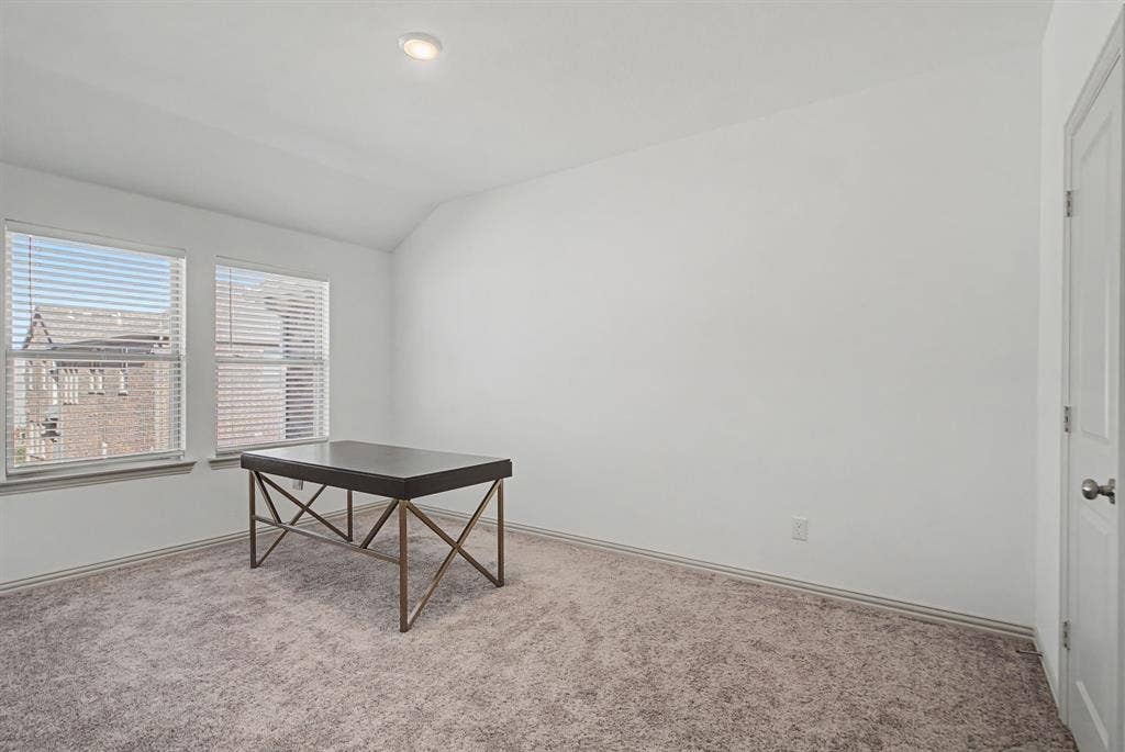 6032 Silverado Trail, McKinney, TX 75070 Room with neutral carpet flooring, white walls, and a vaulted ceiling