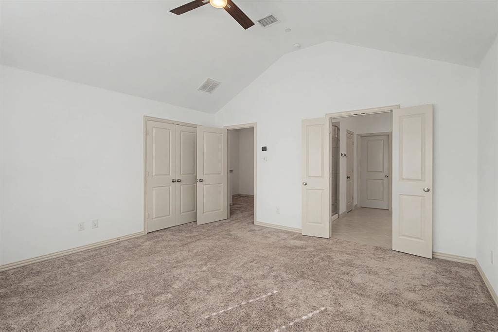 6032 Silverado Trail, McKinney, TX 75070 Spacious room featuring vaulted ceilings, light neutral carpeting, and a ceiling fan