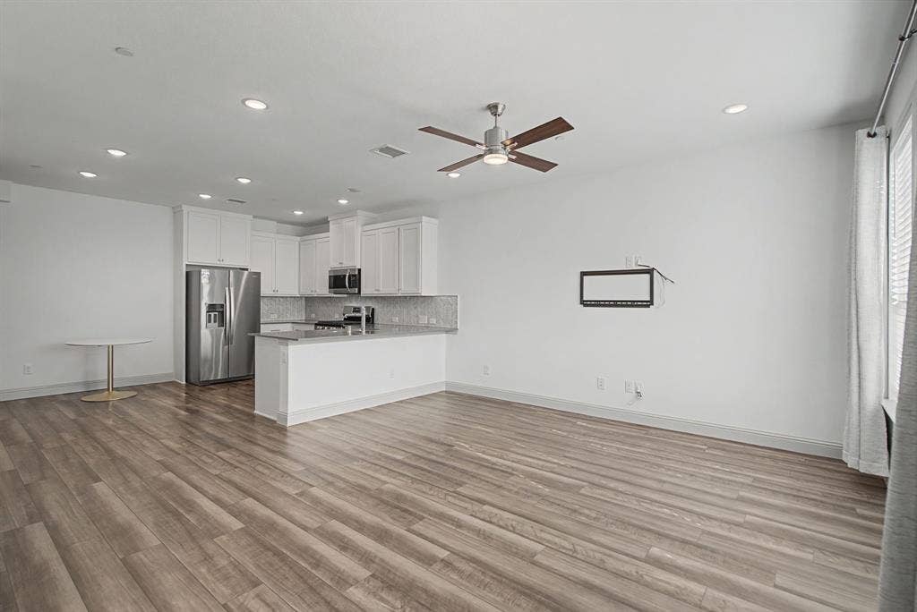 6032 Silverado Trail, McKinney, TX 75070 Open-concept living area featuring wood-finish flooring, recessed lighting, and a ceiling fan