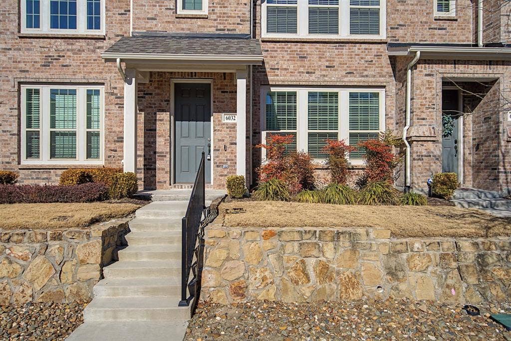 6032 Silverado Trail, McKinney, TX 75070 Brick facade with white-framed windows and a covered entryway