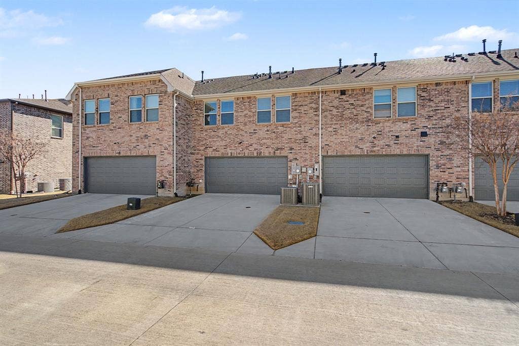 6032 Silverado Trail, McKinney, TX 75070 Brick exterior townhome with an attached two-car garage