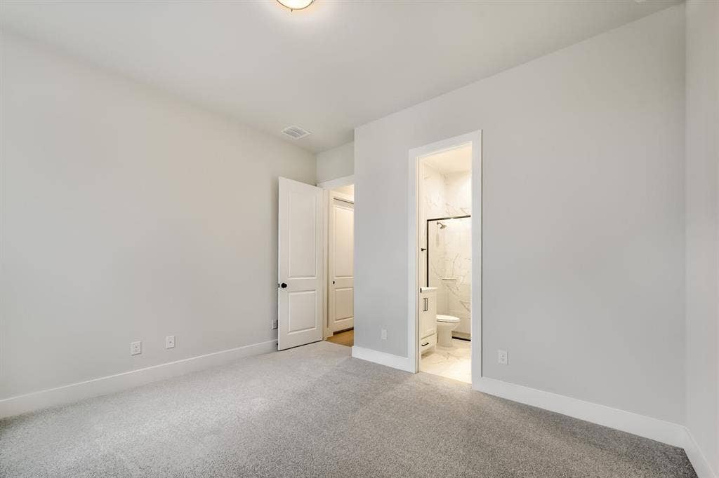 Plush grey carpeting and light grey wall paint define this interior space