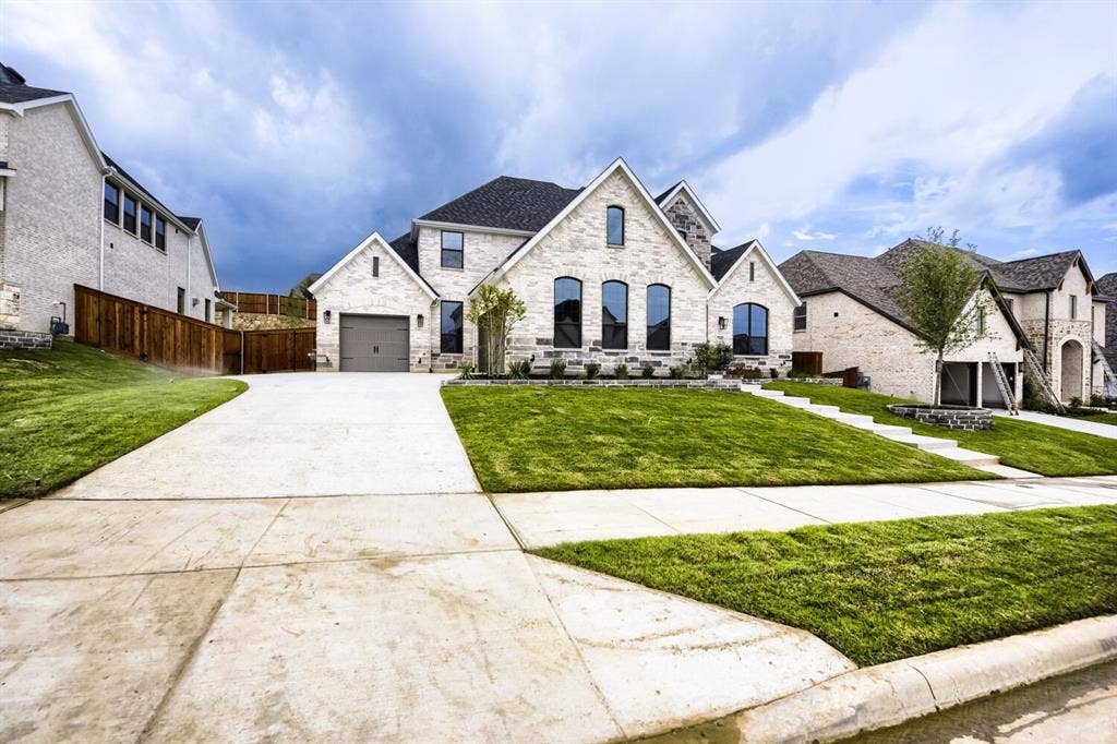Stone veneer exterior with dark shingle roof