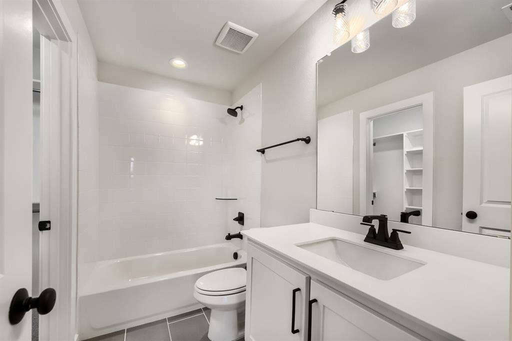 Bathroom with a white subway tile shower surround and an integrated tub