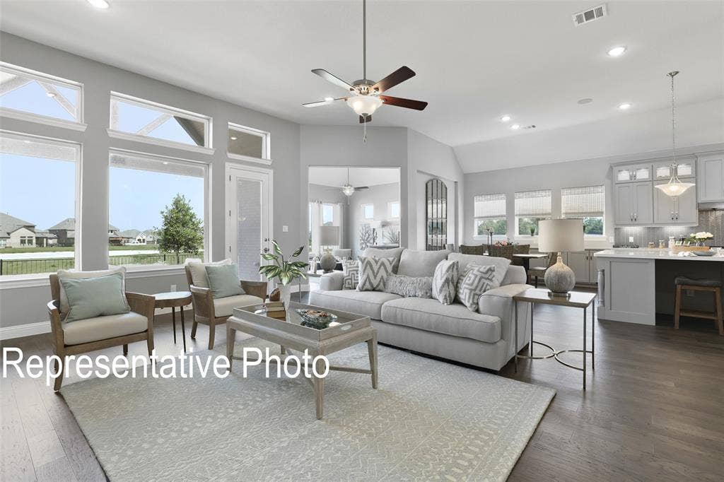 4384 Laurel Trail, Midlothian, TX 76065 Spacious living area featuring expansive windows, recessed lighting, wood-finish flooring, a ceiling fan, and an open-concept kitchen with pendant lighting