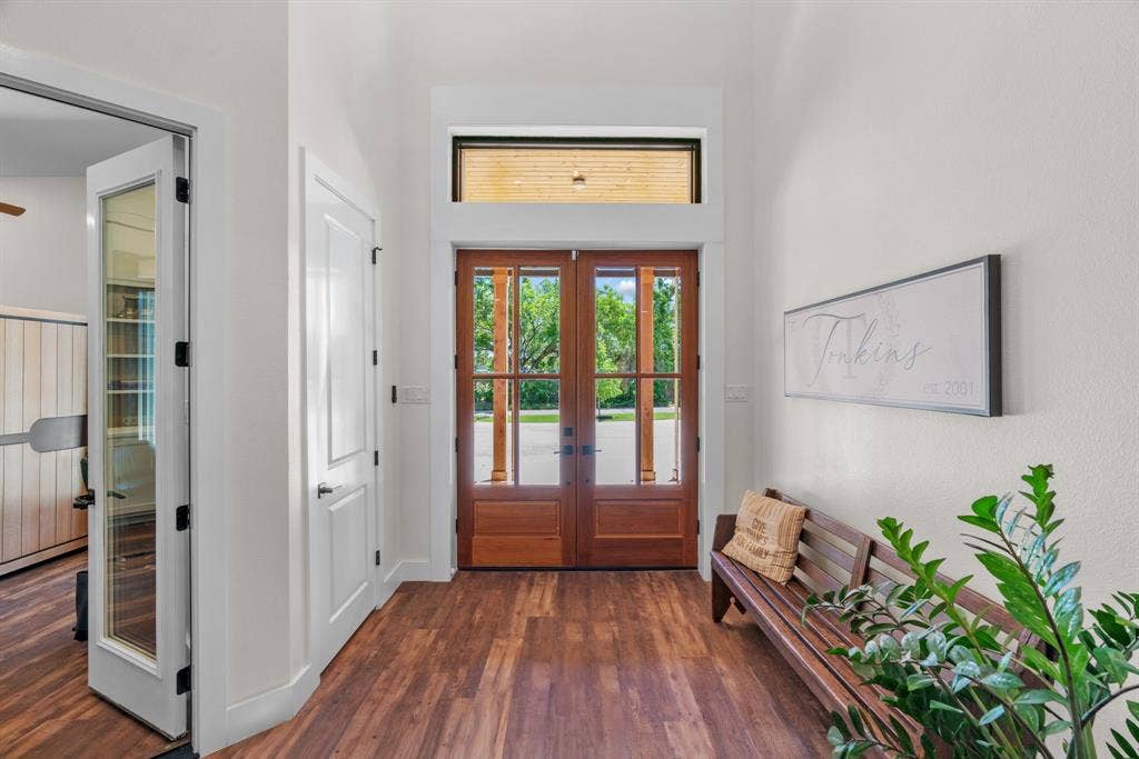3621 Fritz Lane, Corinth, TX 76208 Entryway featuring wood-finish flooring, a double wood-paneled and glass door, and a transom window
