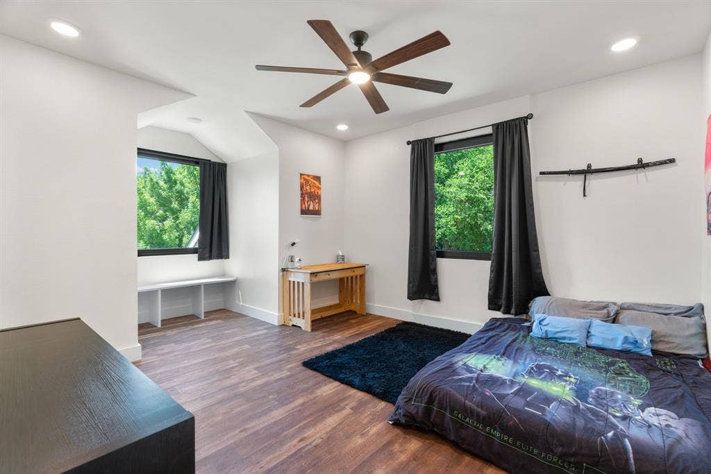 3621 Fritz Lane, Corinth, TX 76208 Spacious room featuring wood-finish flooring, two windows with black frames, recessed lighting, and a ceiling fan