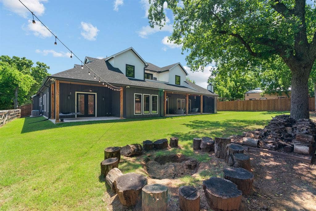 3621 Fritz Lane, Corinth, TX 76208 Expansive backyard featuring a large green lawn, perimeter fencing, and mature trees