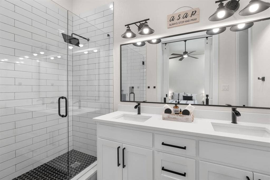 3621 Fritz Lane, Corinth, TX 76208 Double vanity with white cabinetry and integrated sinks, quartz countertop, and matte black hardware