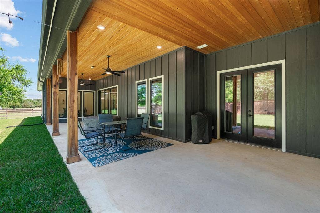 3621 Fritz Lane, Corinth, TX 76208 Expansive covered patio featuring a wood-finish ceiling, recessed lighting, and dual ceiling fans