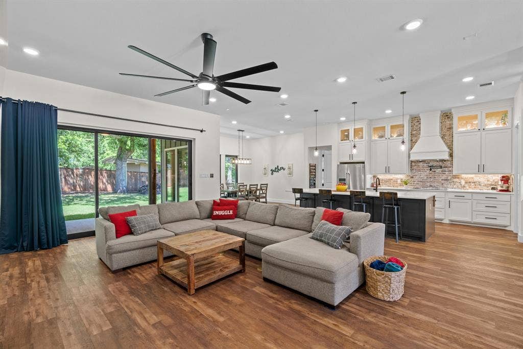 3621 Fritz Lane, Corinth, TX 76208 Open-concept living area featuring wood-finish flooring, recessed lighting, and a large ceiling fan