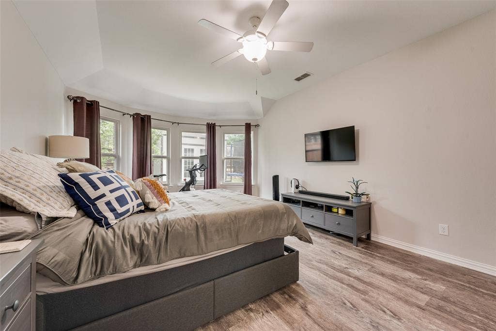 1432 Westview Lane, Northlake, TX 76226 Primary bedroom with new LVP flooring, ensuite bathroom and abundant natural light at 1432 Westview Ln in the Canyon Falls community in Northlake, TX