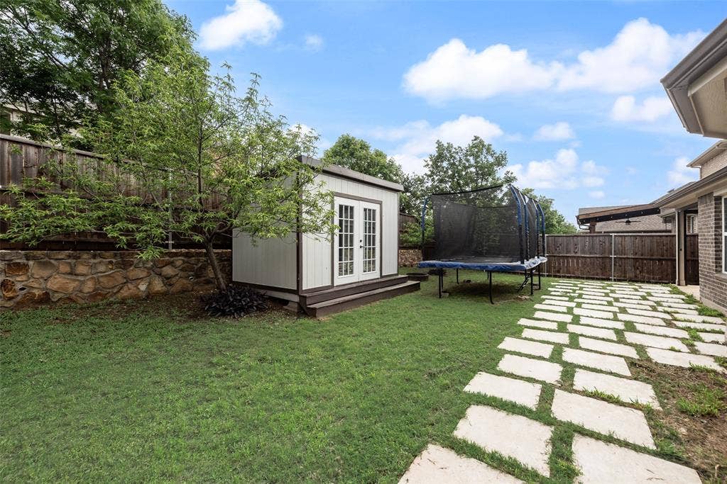 1432 Westview Lane, Northlake, TX 76226 Backyard with concrete pavers and storage shed at 1432 Westview Ln in the Canyon Falls community in Northlake, TX
