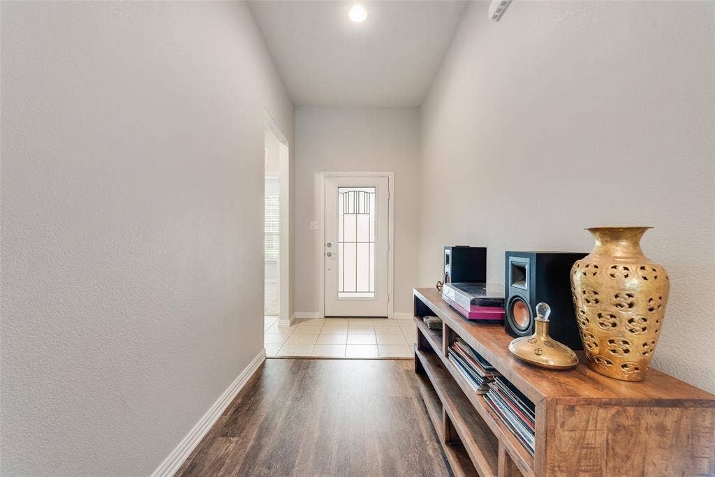 1432 Westview Lane, Northlake, TX 76226 Brand new LVP floors in entry with hallway leading to two bedrooms and bathroom on the left at 1432 Westview Ln in the Canyon Falls community in Northlake, TX