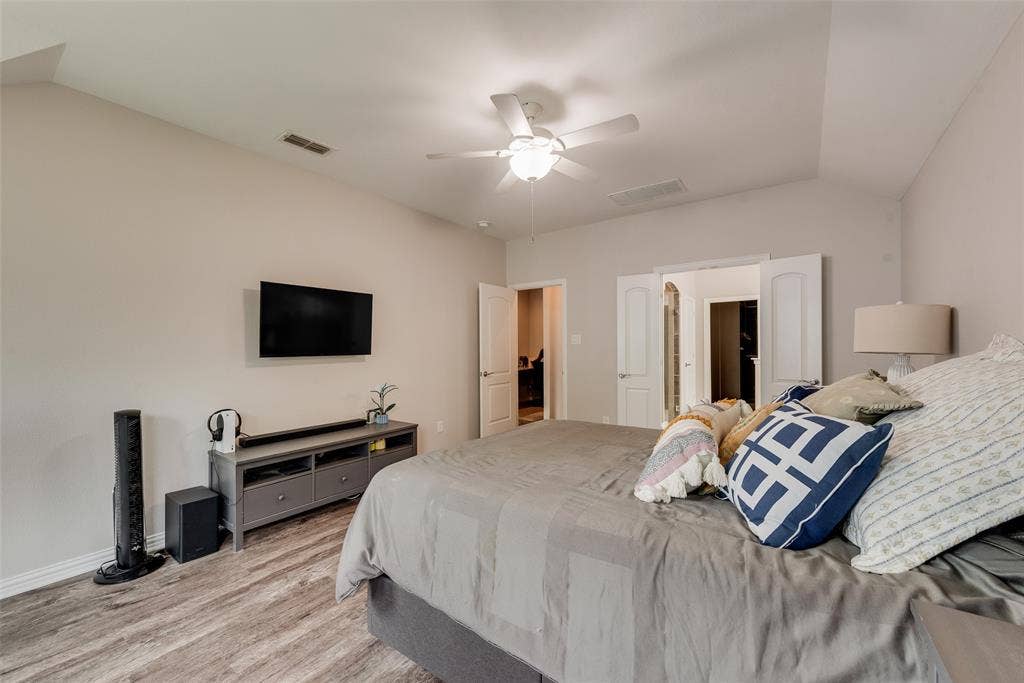 1432 Westview Lane, Northlake, TX 76226 Primary bedroom with new LVP flooring, ensuite bathroom and abundant natural light at 1432 Westview Ln in the Canyon Falls community in Northlake, TX