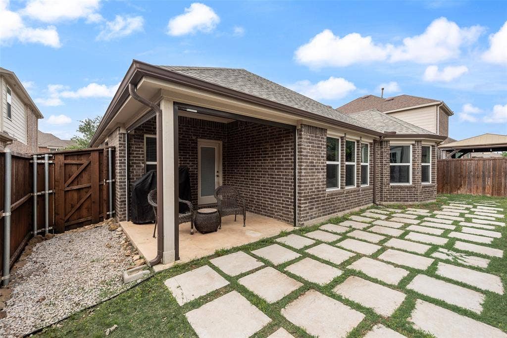 1432 Westview Lane, Northlake, TX 76226 Backyard covered patio with drop down screens at 1432 Westview Ln in the Canyon Falls community in Northlake, TX