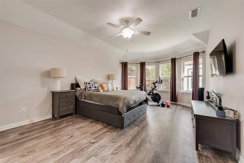 1432 Westview Lane, Northlake, TX 76226 Primary bedroom with new LVP flooring, ensuite bathroom and abundant natural light at 1432 Westview Ln in the Canyon Falls community in Northlake, TX