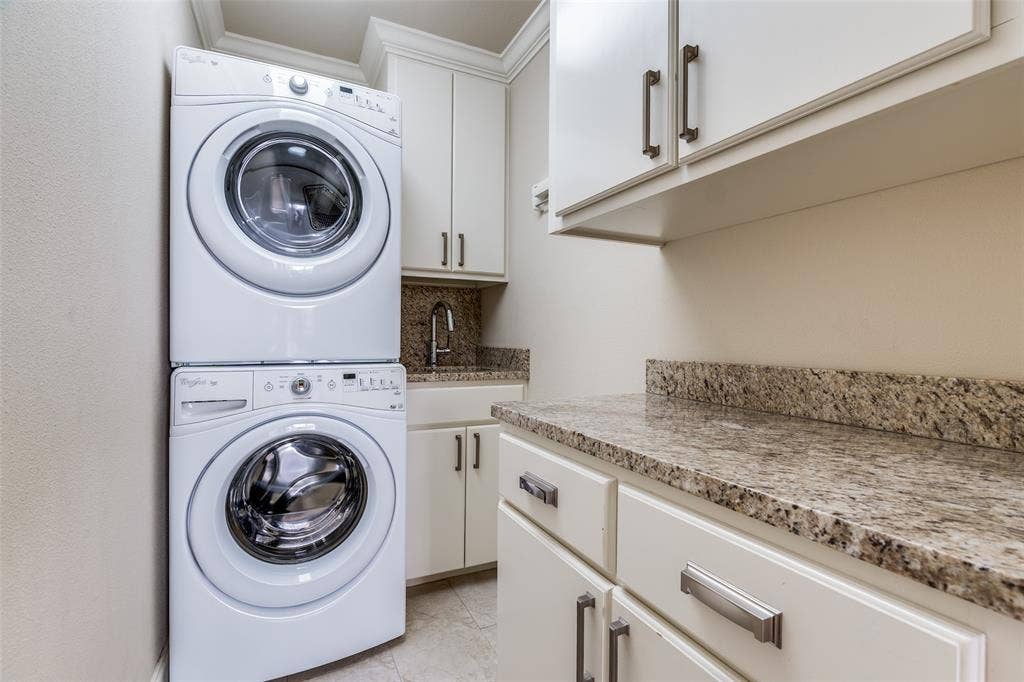 3831 Turtle Creek Boulevard, #15E, Dallas, TX 75219 Laundry with stacking washer and dryer.