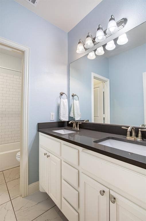 1408 9th Street, Argyle, TX 76226 The third full bathroom features double sinks and is conveniently located just outside two of the secondary bedrooms, offering both functionality and easy access.