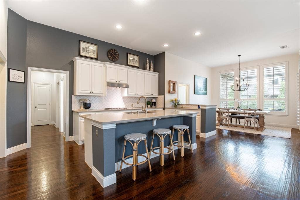 1408 9th Street, Argyle, TX 76226 The kitchen features a breakfast bar, providing additional seating and a perfect spot for casual dining or entertaining.