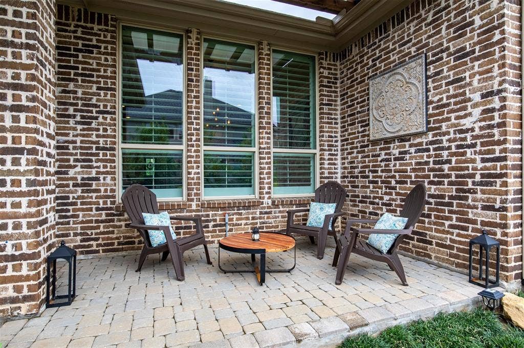 1408 9th Street, Argyle, TX 76226 An additional peaceful outdoor sitting area overlooks the beautiful backyard, creating a serene spot to relax and enjoy the view.