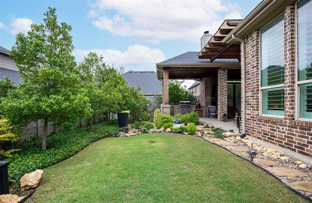 1408 9th Street, Argyle, TX 76226 The mature landscaping in this backyard not only enhances its beauty but also provides an added sense of privacy and seclusion.