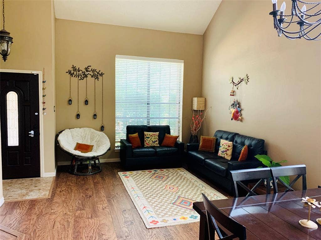 1848 Sonnet Drive, Grapevine, TX 76051 Entry area featuring a dark paneled door with an arched glass insert, high vaulted ceilings, and wood-finish flooring