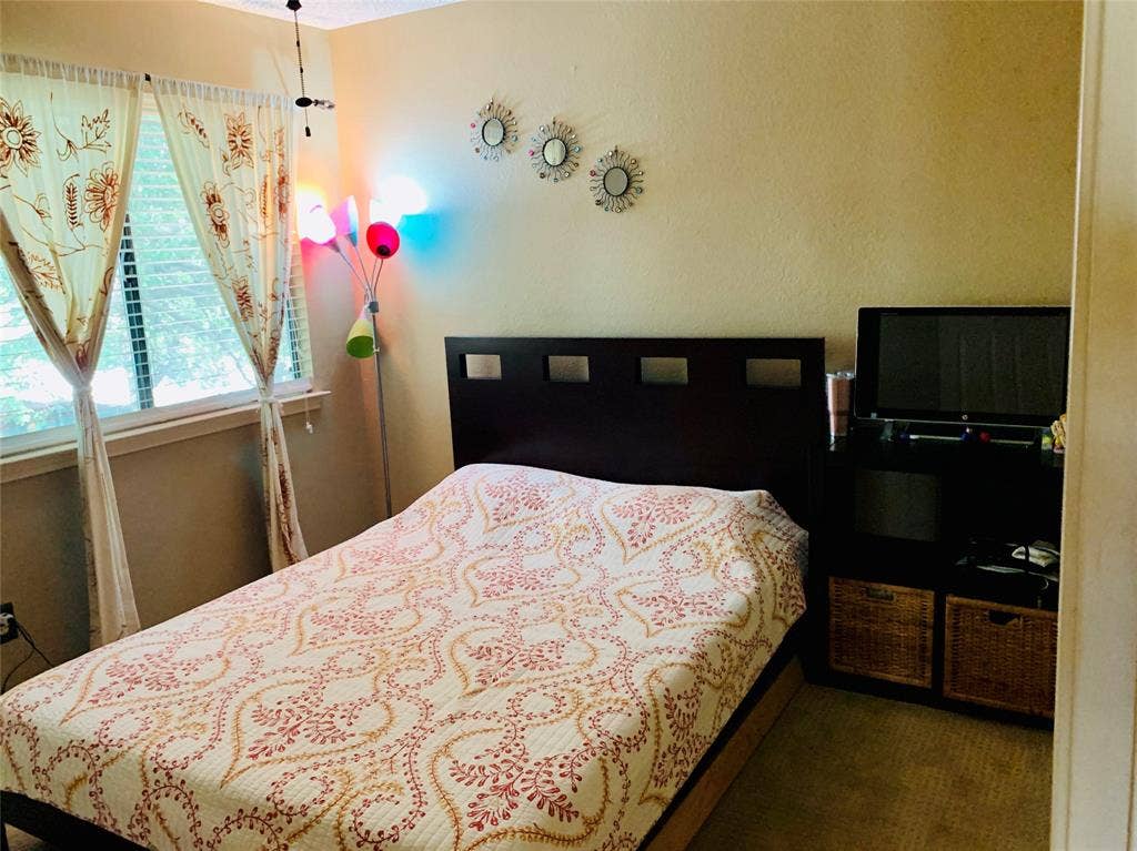 1848 Sonnet Drive, Grapevine, TX 76051 Bedroom with window featuring horizontal blinds, and a built-in shelving unit