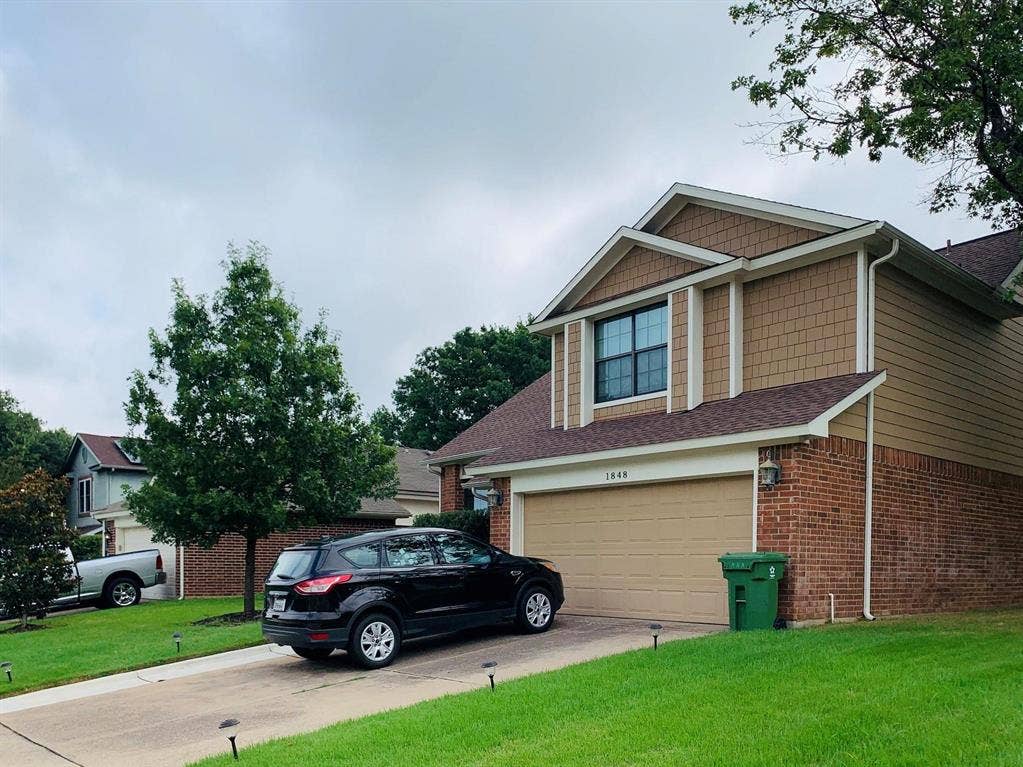 1848 Sonnet Drive, Grapevine, TX 76051 Two-story residence featuring brick and siding exterior with shingle accents