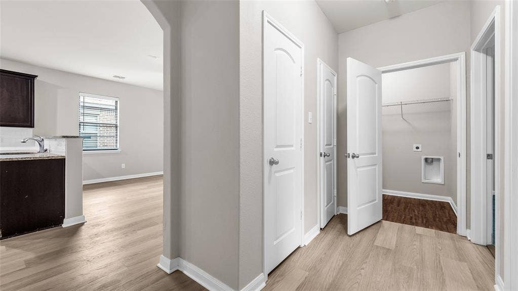 Hallway to additional bedrooms, hall closets, laundry and guest bath.