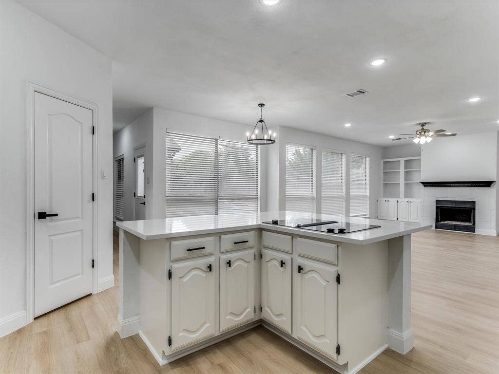 736 Sunkist Lane, Plano, TX 75025 Kitchen island featuring a built-in cooktop and light-toned countertop