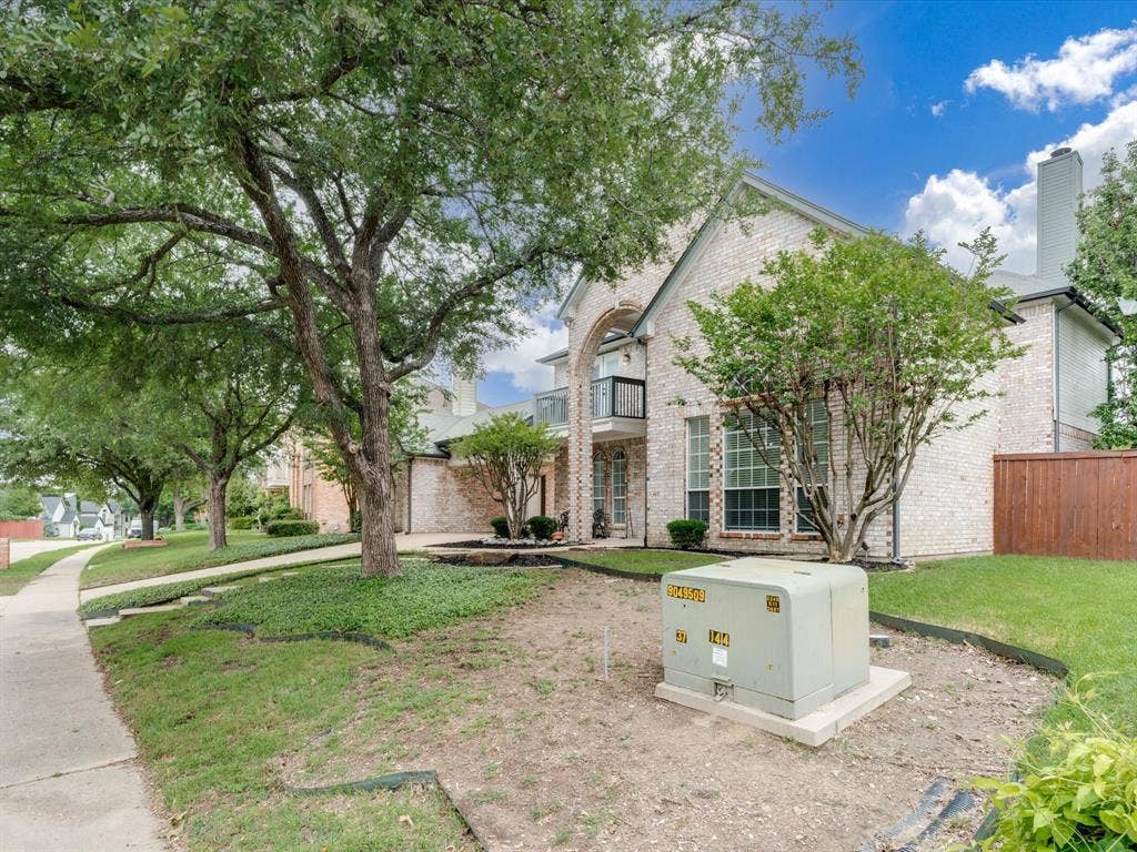 736 Sunkist Lane, Plano, TX 75025 Brick facade residence featuring a prominent arched entrance