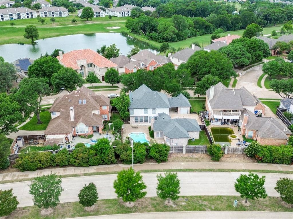736 Sunkist Lane, Plano, TX 75025 Expansive backyard featuring an inground swimming pool, surrounding patio space, and mature perimeter landscaping