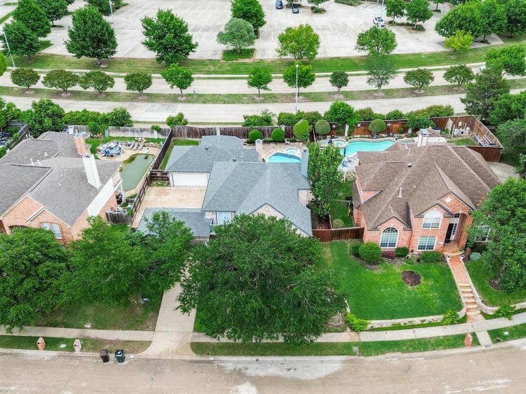 736 Sunkist Lane, Plano, TX 75025 Two-story brick residence featuring a multi-gabled roof and an arched entry