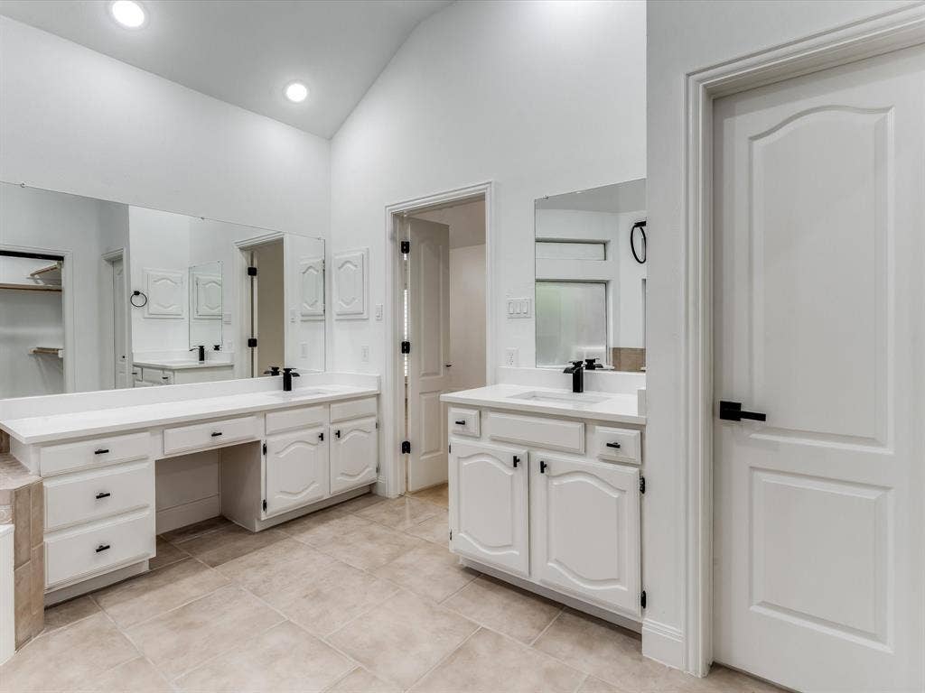 736 Sunkist Lane, Plano, TX 75025 White vaulted ceilings featuring recessed lighting, a dual vanity with white cabinetry, white countertops, and black fixtures
