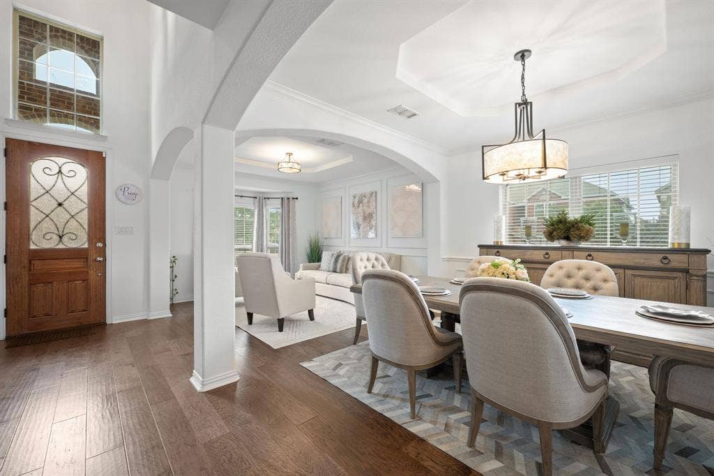 Wood-finish flooring throughout, featuring an arched entryway with natural lighting throughout