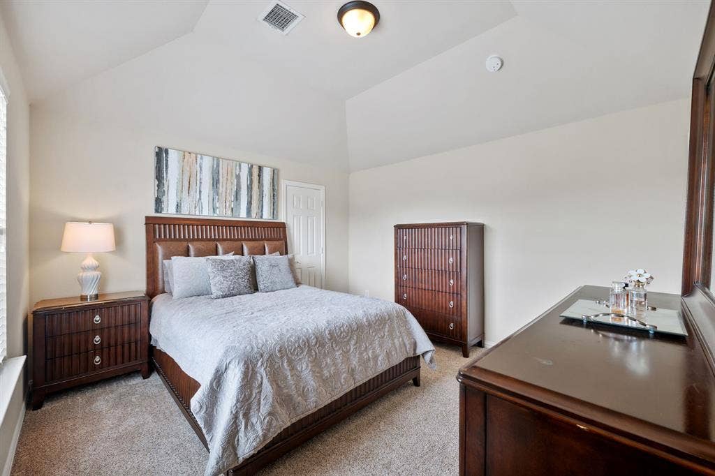 Vaulted ceiling room with neutral-toned walls