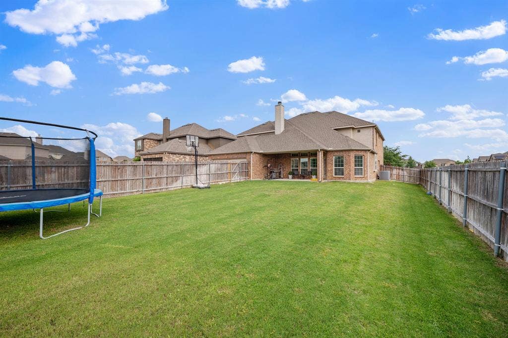 Expansive lawn area with a wood fence