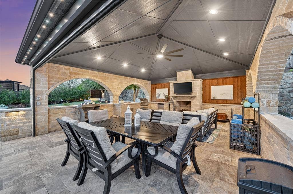 7108 Eagles Ridge Court, Argyle, TX 76226 The oversized cabana is an entertainer’s dream, complete with a wood-burning fireplace, outdoor kitchen, and remote-controlled screens for year-round comfort.