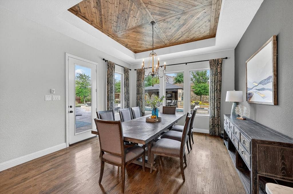 7108 Eagles Ridge Court, Argyle, TX 76226 Designed for both everyday living and entertaining, the oversized dining area features a custom wood-inlay tray ceiling.
