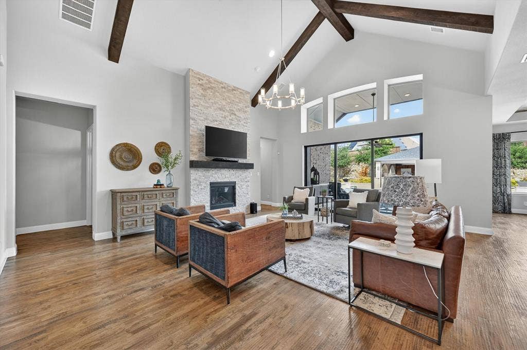 7108 Eagles Ridge Court, Argyle, TX 76226 From the moment you enter, your eye is drawn through expansive 3-panel sliding pocket doors to a stunning pool view, creating a seamless indoor-outdoor living experience.