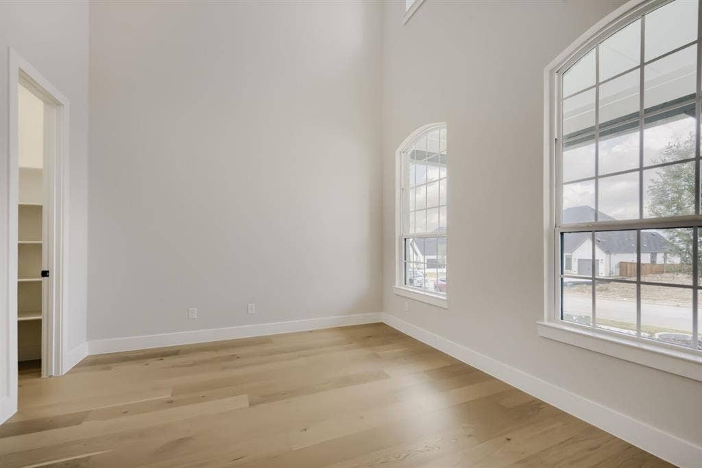794 White Sage Road, Haslet, TX 76052 Hardwood-style flooring extends across this room featuring arched windows