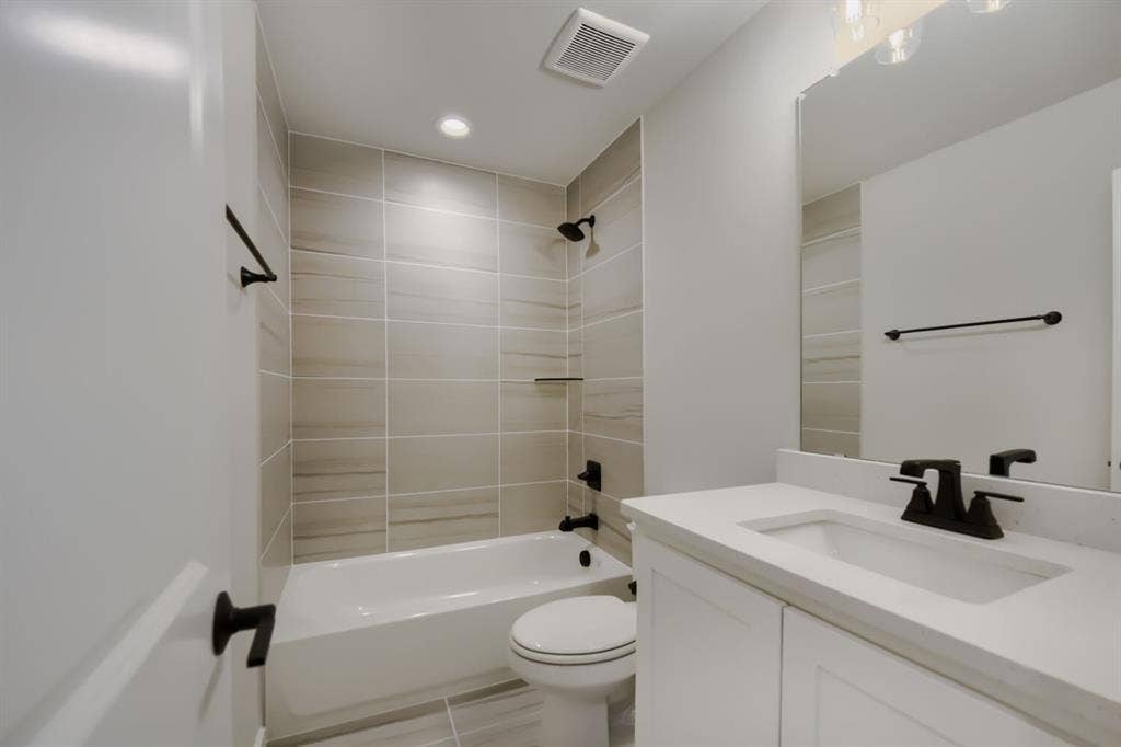 794 White Sage Road, Haslet, TX 76052 Bathroom featuring a vanity with a white countertop and integrated sink, matte black faucet, and a large mirror