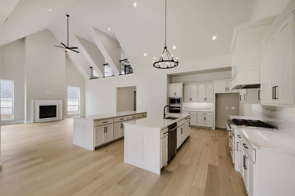 794 White Sage Road, Haslet, TX 76052 Open-concept living space featuring vaulted ceilings with exposed beams and wood-finish flooring