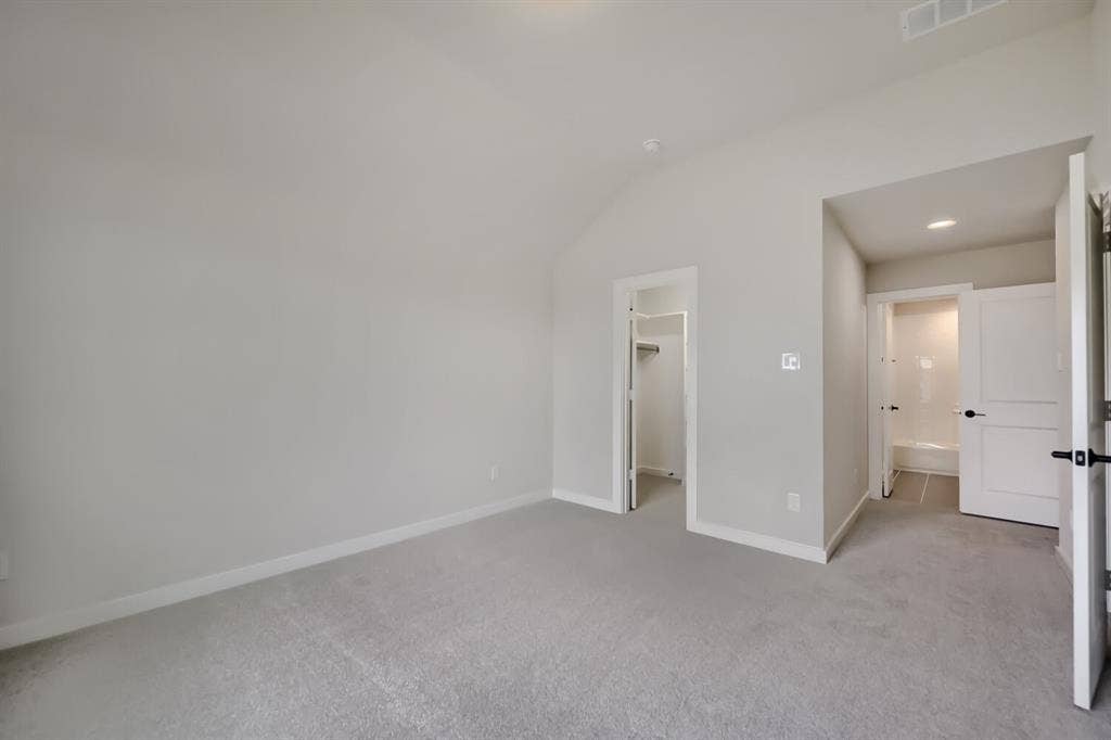 794 White Sage Road, Haslet, TX 76052 Carpeted bedroom with vaulted ceiling and light gray walls